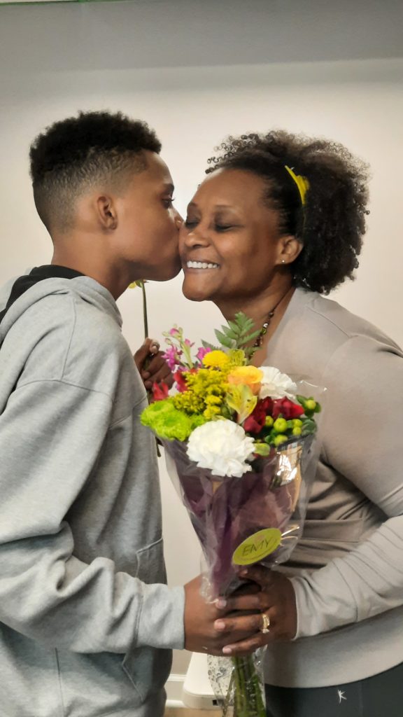 Enjoying a mom moment when my son gave me flowers!